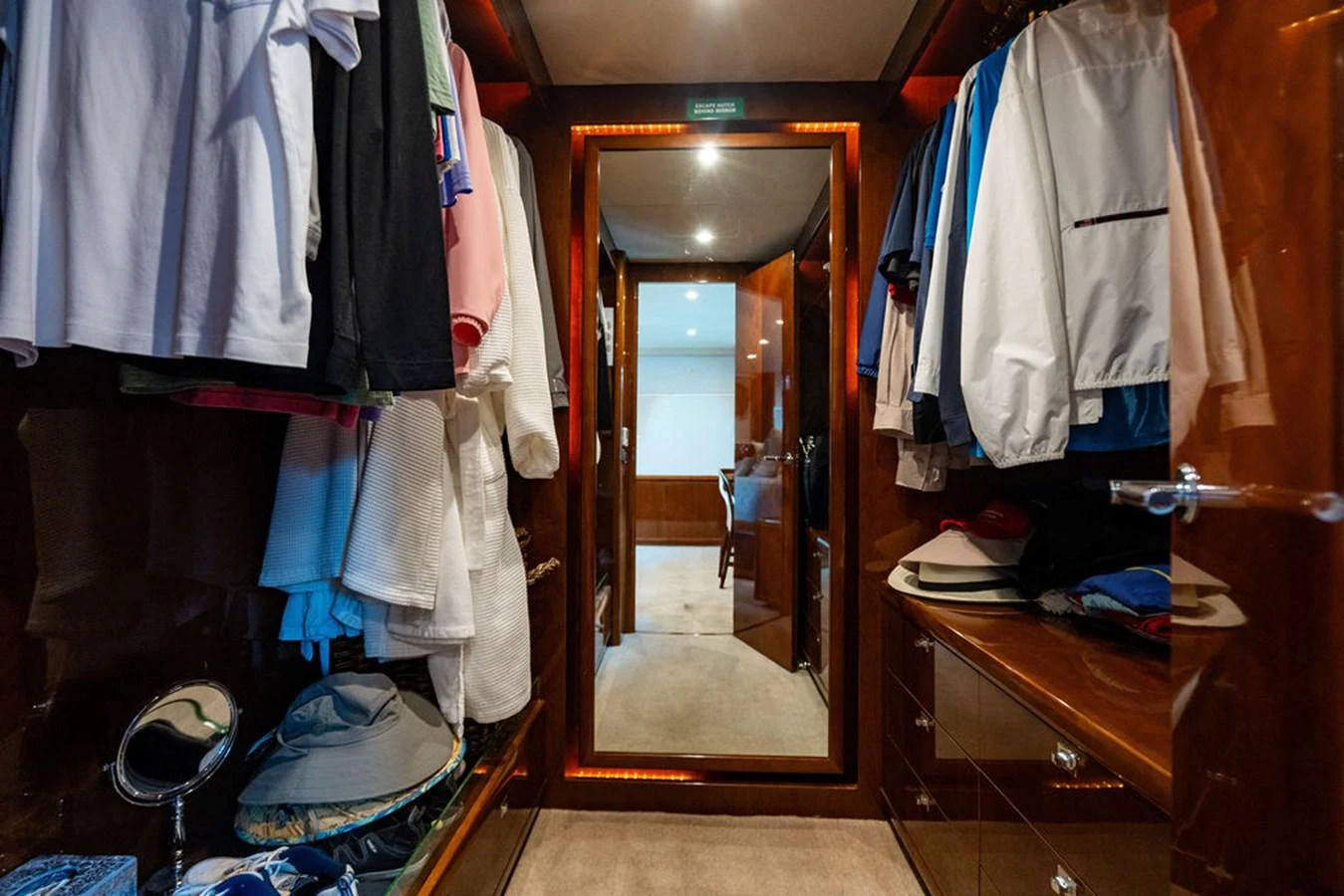 A well-organized closet with ample storage space and elegant lighting. aboard OASIS Yacht for Sale