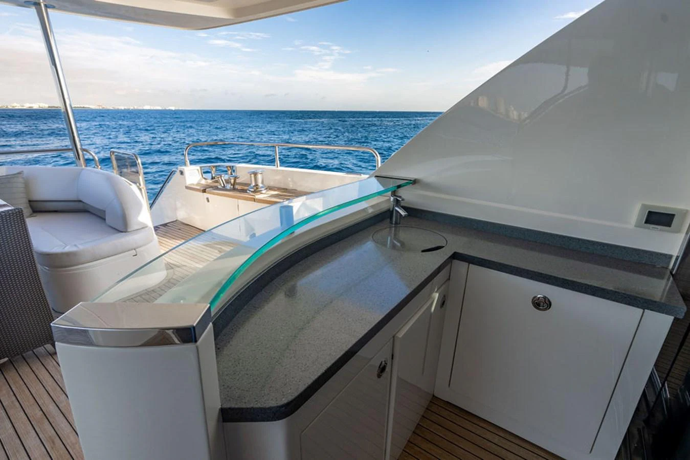 The yacht features a sleek wet bar on the aft deck, perfect for entertaining with a stunning ocean view. aboard OASIS Yacht for Sale