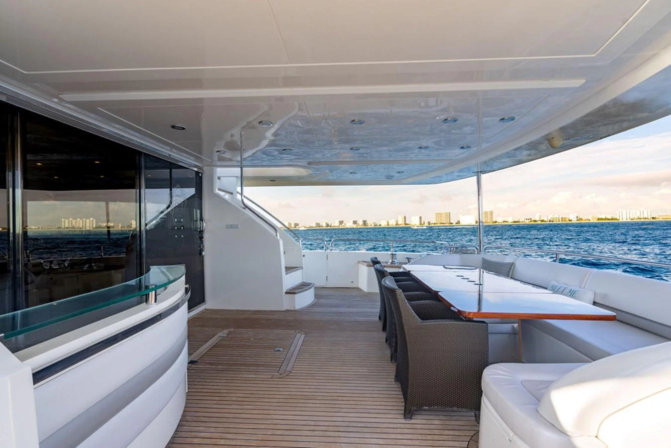 The spacious aft deck offers a luxurious outdoor dining area with stunning ocean views. aboard OASIS Yacht for Sale
