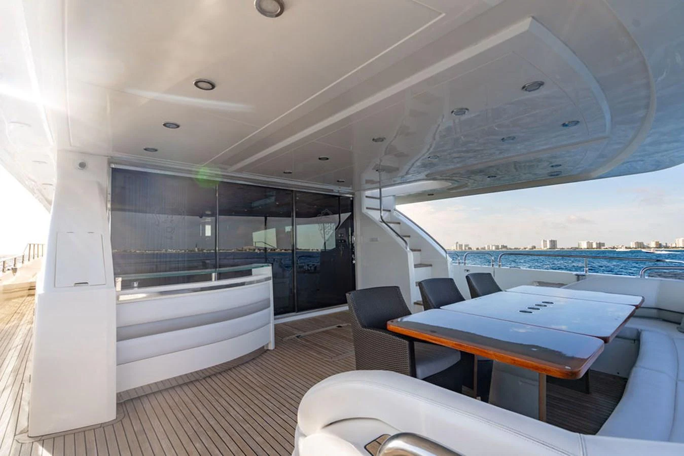The aft deck offers a spacious and luxurious outdoor dining area with stunning views of the water. aboard OASIS Yacht for Sale