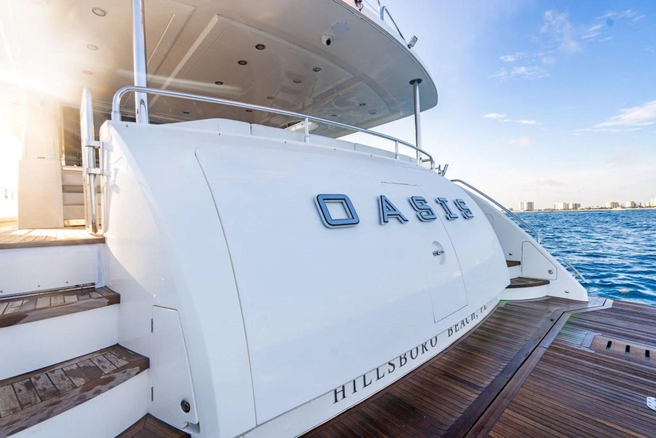 The aft deck of the yacht features elegant steps and a spacious platform, perfect for easy access to the water. aboard OASIS Yacht for Sale