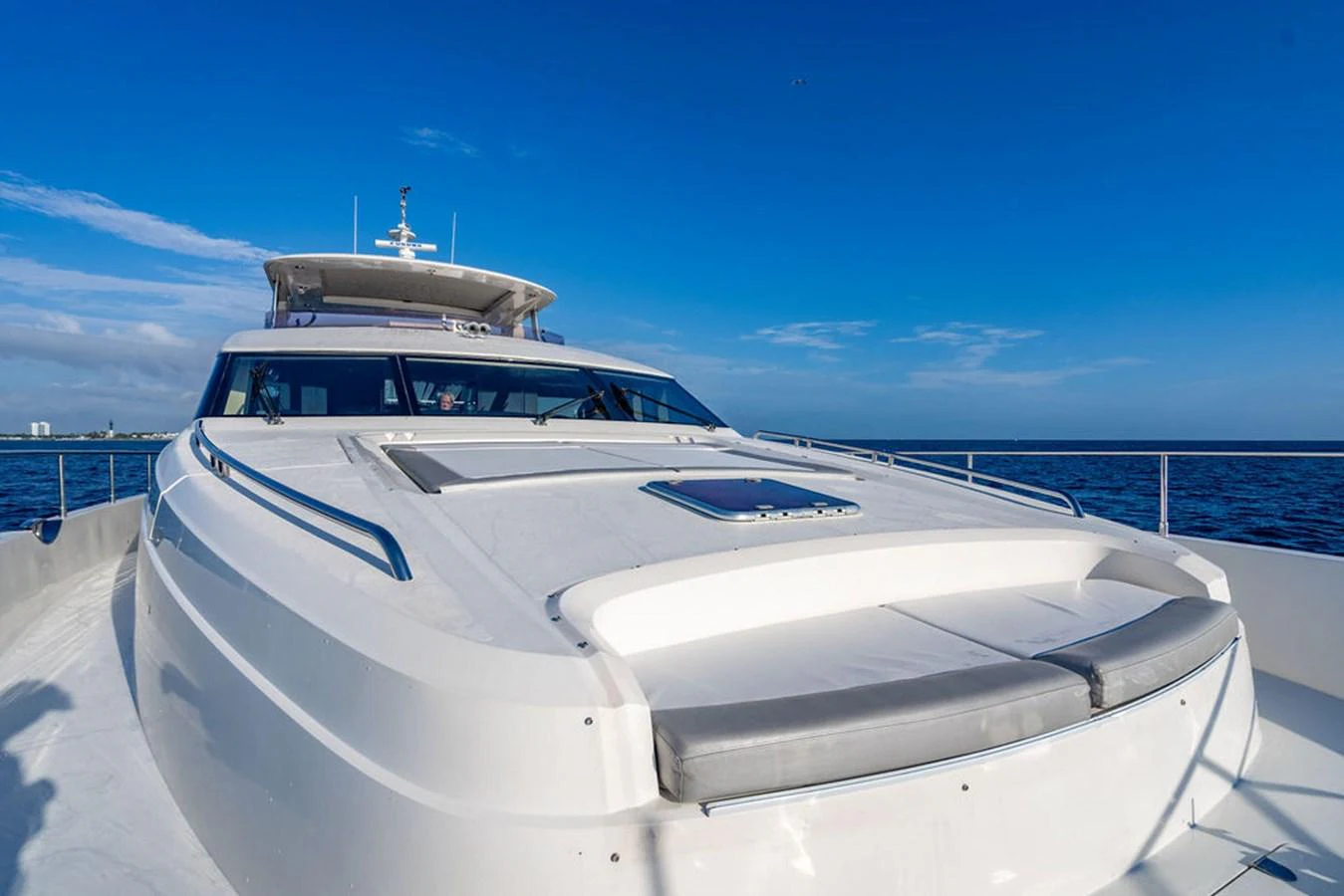 The yacht's foredeck offers a sleek and spacious area for relaxation with stunning ocean views. aboard OASIS Yacht for Sale