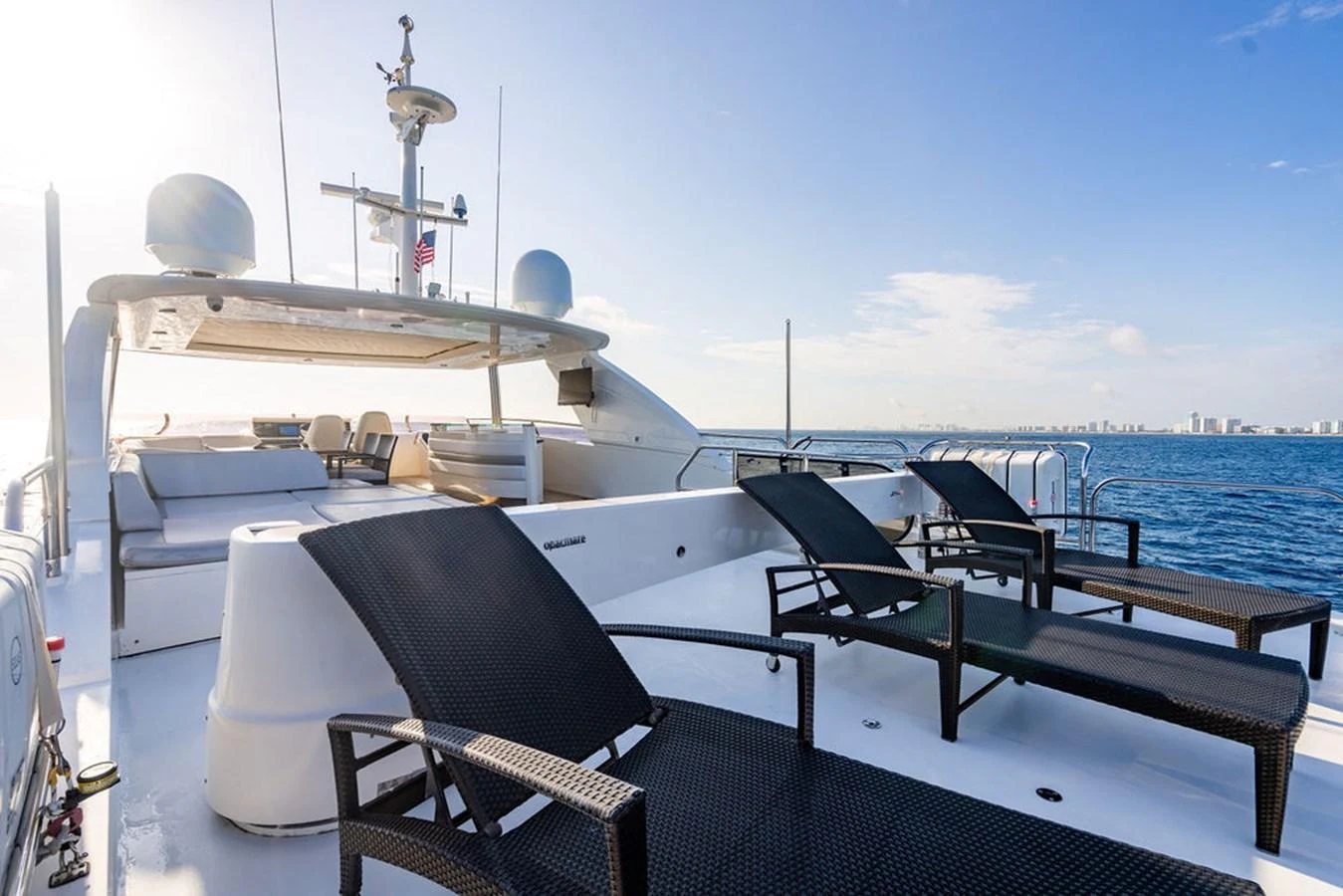 The sundeck offers a luxurious space with sun loungers and a stunning ocean view. aboard OASIS Yacht for Sale