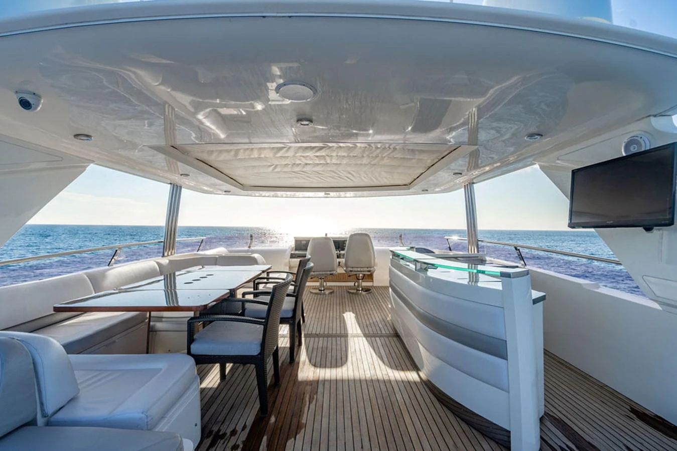 The flybridge offers a spacious and luxurious area for relaxation and entertainment with stunning ocean views. aboard OASIS Yacht for Sale