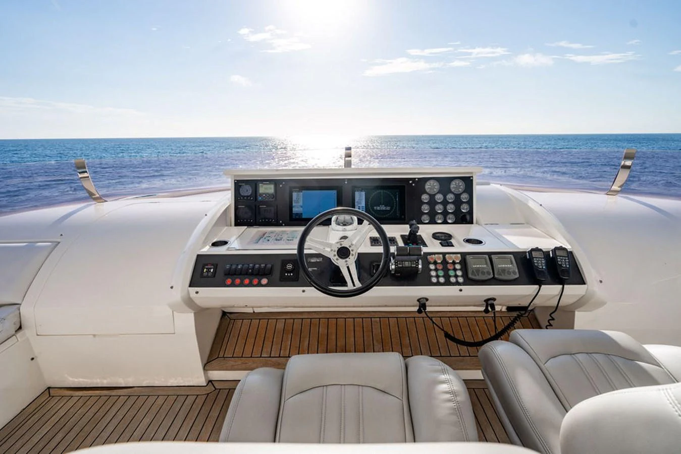 The helm station offers a commanding view of the open sea, equipped with advanced navigation instruments and luxurious seating. aboard OASIS Yacht for Sale