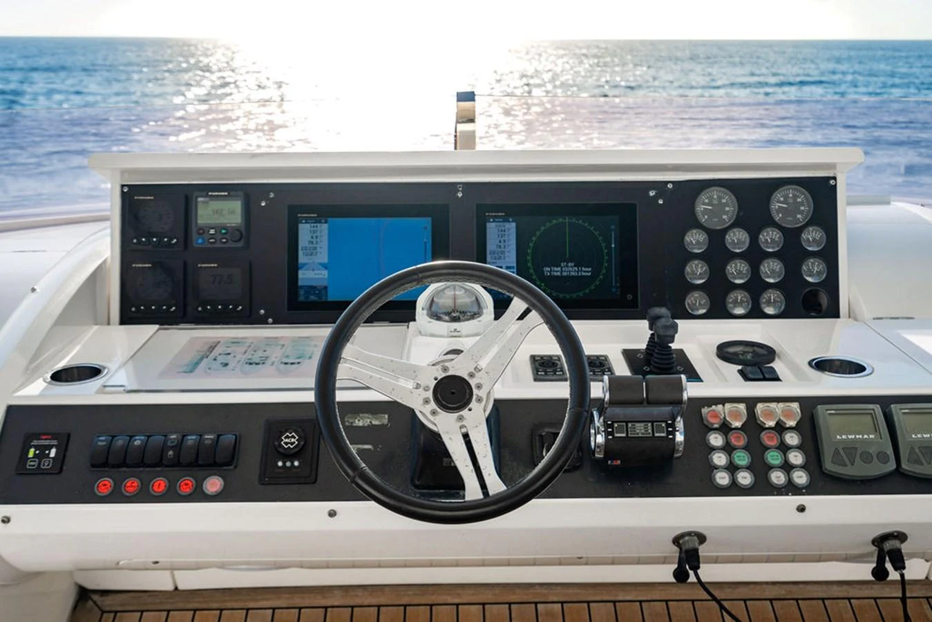 The helm station offers a commanding view of the open sea with advanced navigation equipment and controls. aboard OASIS Yacht for Sale