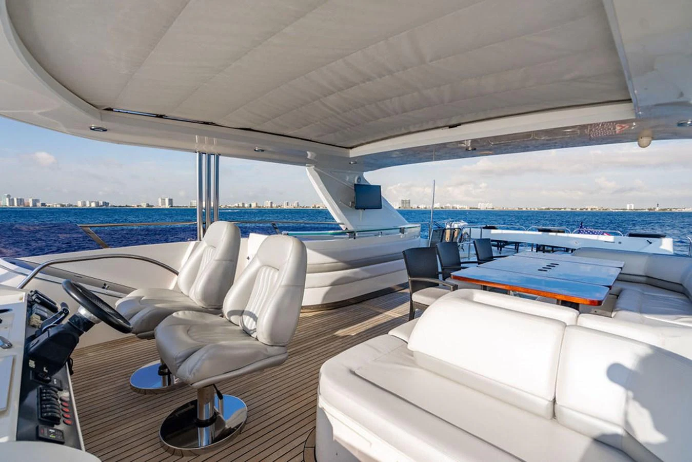The flybridge offers a spacious and luxurious area with comfortable seating and panoramic views of the water. aboard OASIS Yacht for Sale