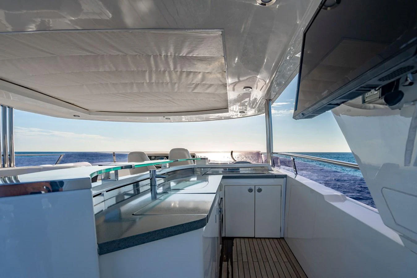 The yacht's galley offers a sleek and modern design with a stunning ocean view. aboard OASIS Yacht for Sale