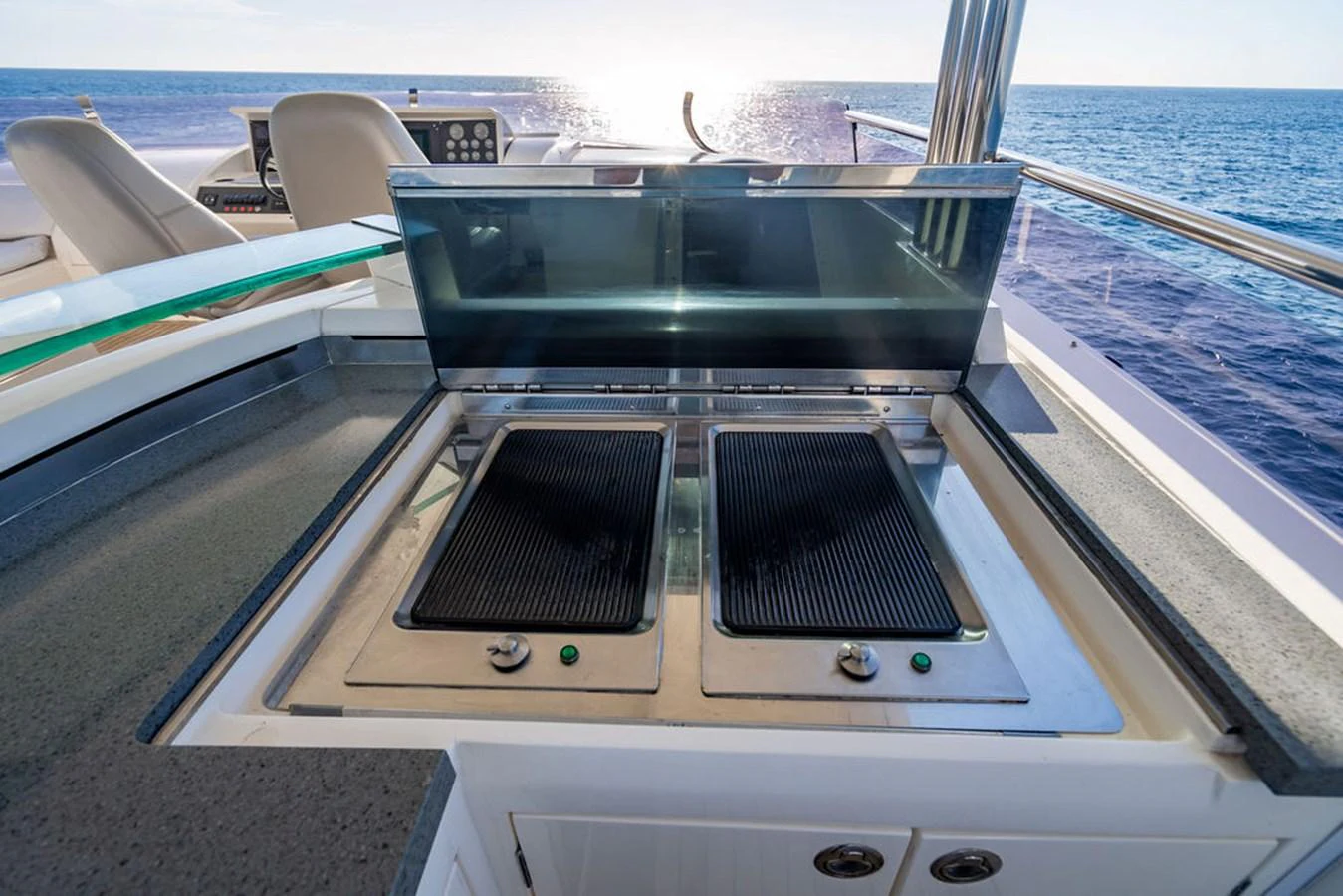 The yacht features a sleek outdoor galley with modern grill stations, perfect for alfresco dining. aboard OASIS Yacht for Sale