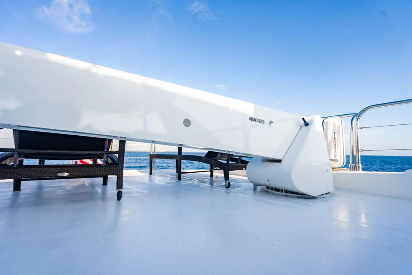 A sleek, modern yacht deck with a focus on clean lines and open space. aboard OASIS Yacht for Sale