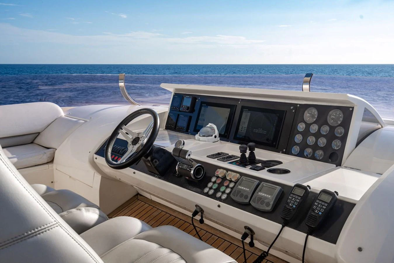 The helm station offers a commanding view of the open sea with state-of-the-art navigation equipment. aboard OASIS Yacht for Sale