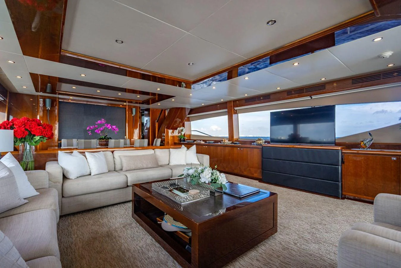 The yacht's salon features luxurious seating and elegant decor with panoramic views. aboard OASIS Yacht for Sale