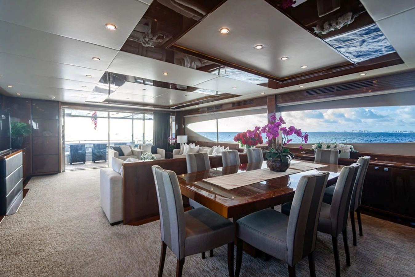 The yacht's dining area features elegant seating and large windows offering stunning ocean views. aboard OASIS Yacht for Sale