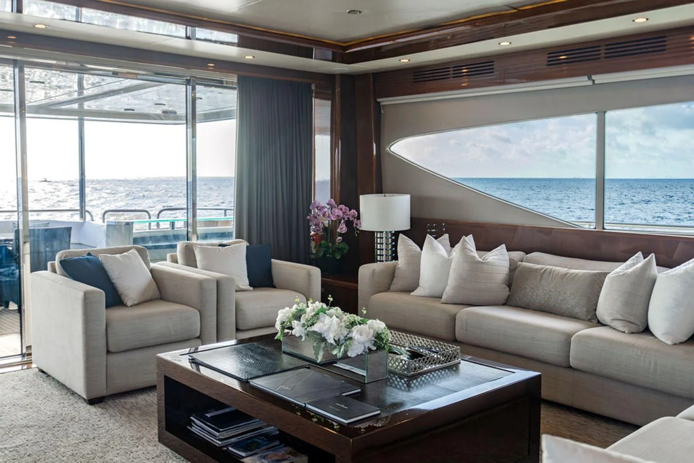 The salon offers a spacious and elegant area for relaxation with a stunning ocean view. aboard OASIS Yacht for Sale