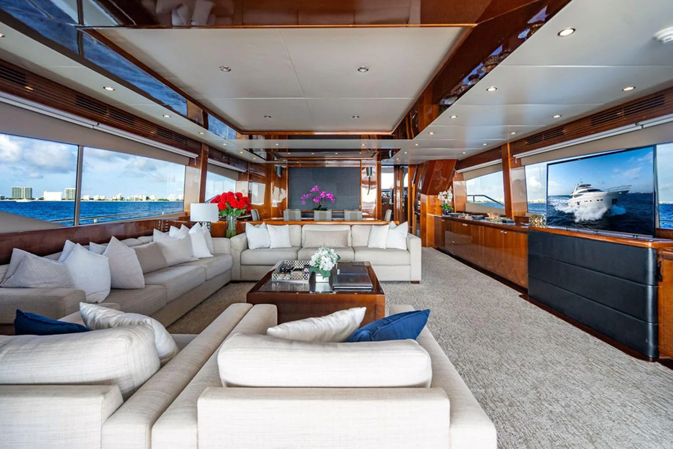 The spacious salon features luxurious seating and panoramic views. aboard OASIS Yacht for Sale