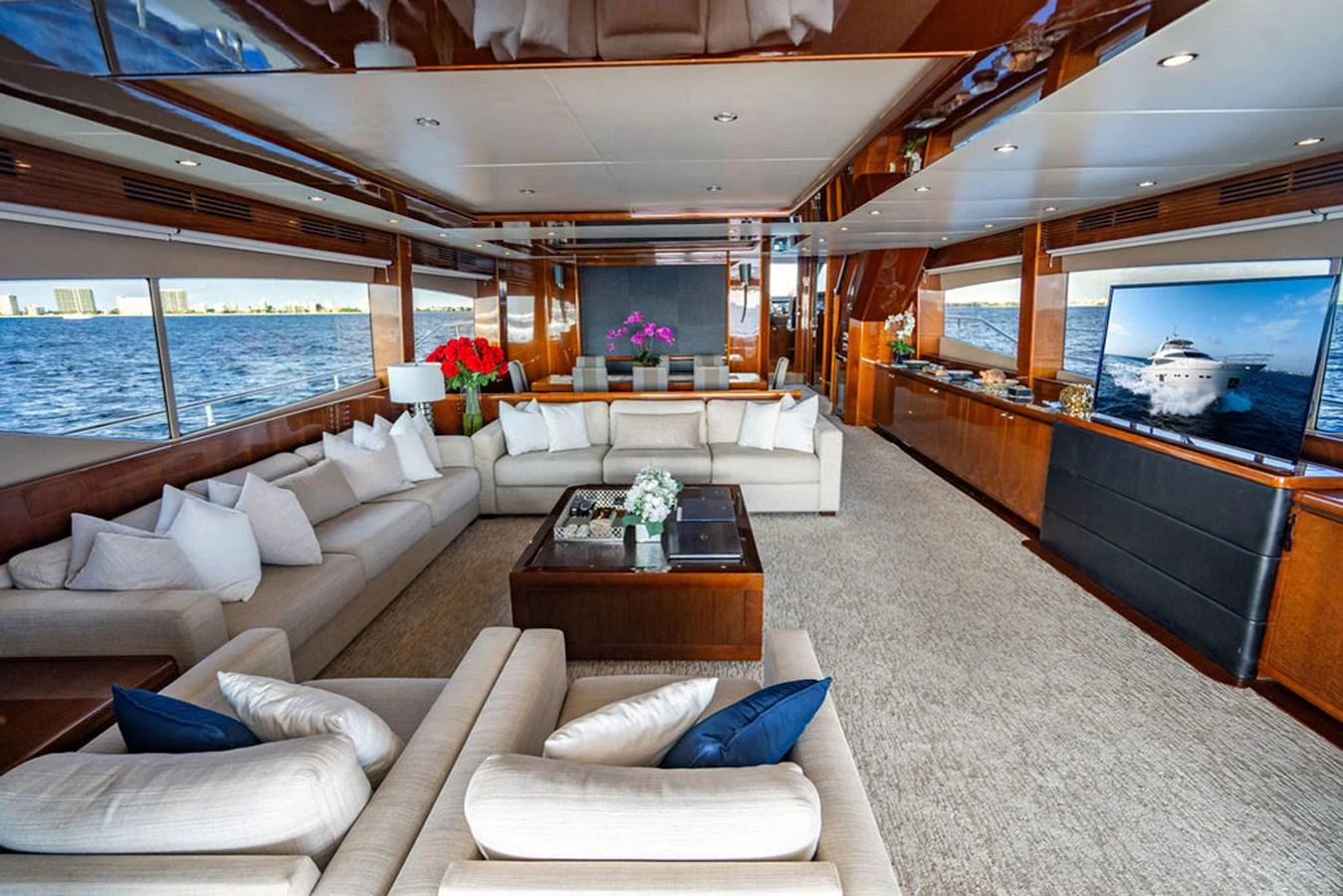 The spacious salon features luxurious seating, large windows, and elegant decor, offering a perfect blend of comfort and style. aboard OASIS Yacht for Sale