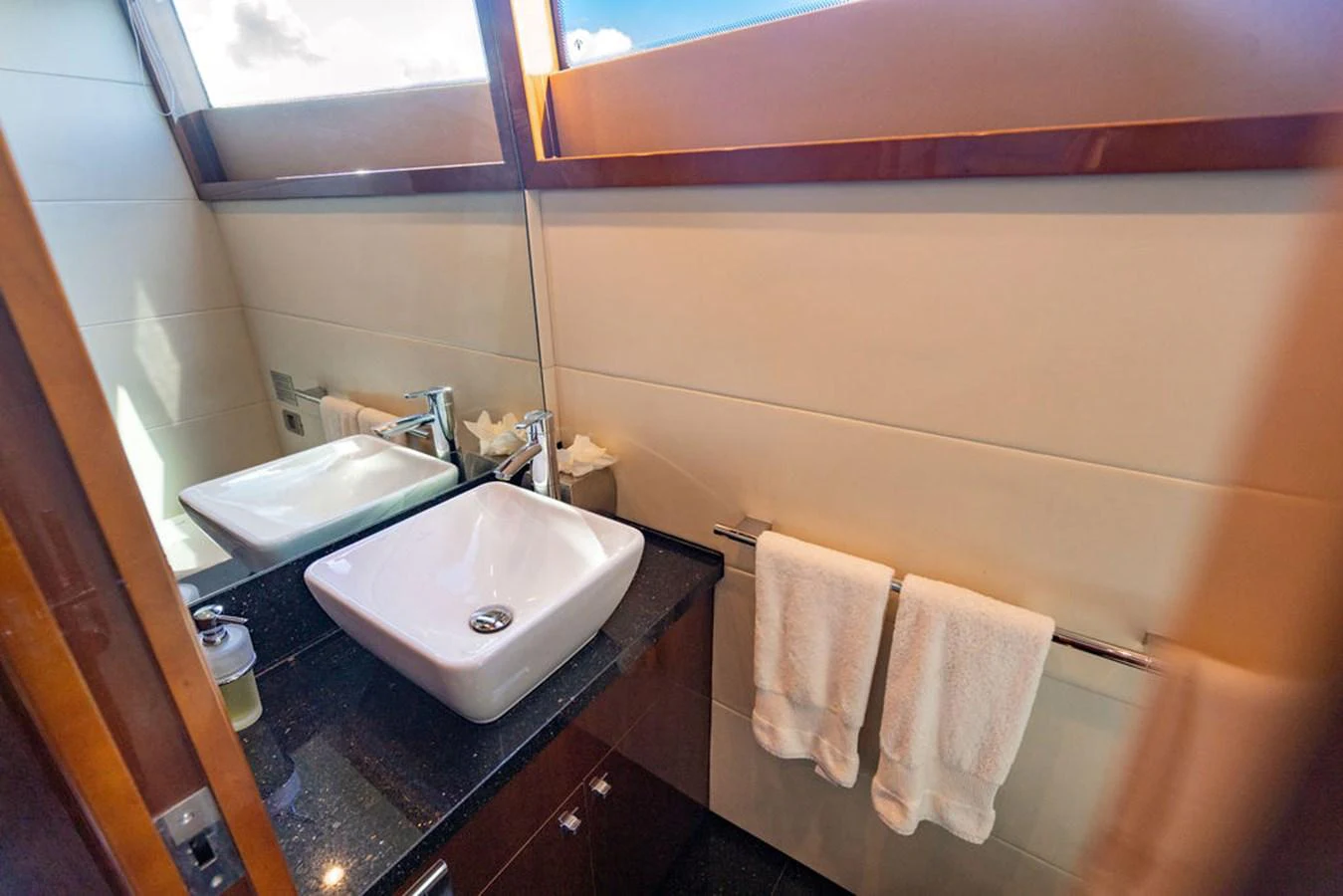 A luxurious yacht bathroom featuring a modern sink and elegant fixtures. aboard OASIS Yacht for Sale