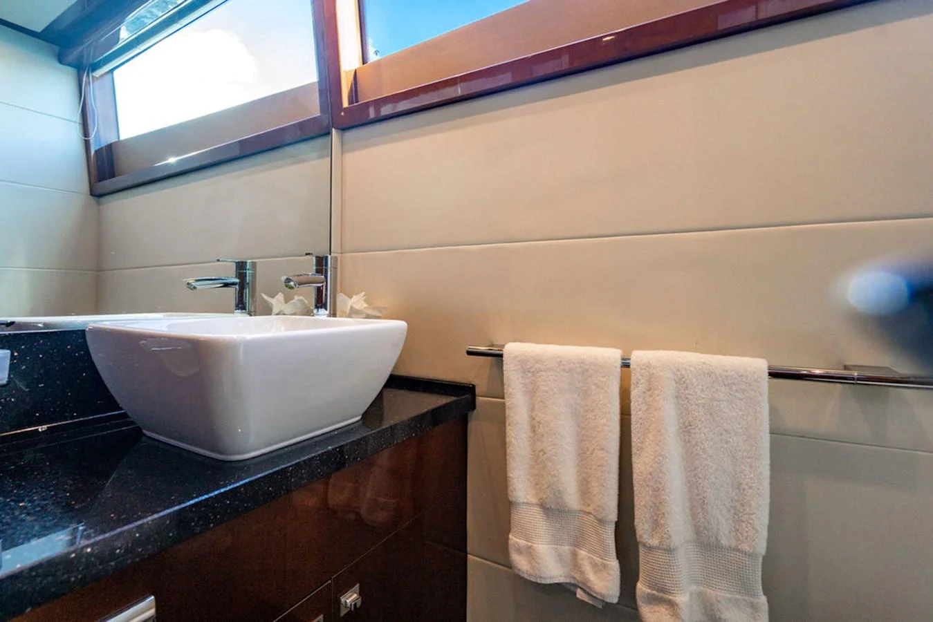 The yacht's bathroom features a modern sink and elegant fixtures. aboard OASIS Yacht for Sale