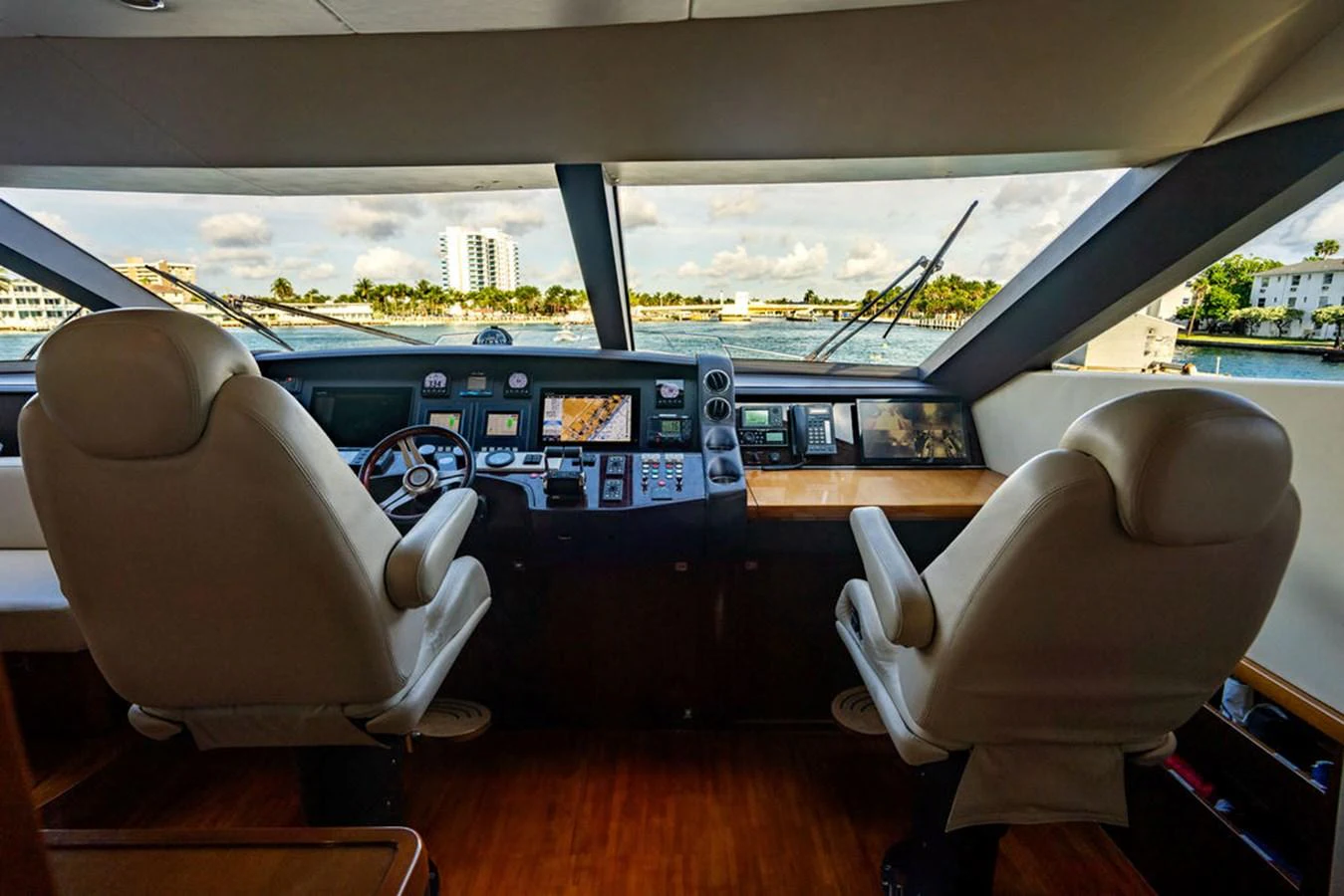 The helm station offers a commanding view with state-of-the-art navigation equipment and luxurious seating. aboard OASIS Yacht for Sale