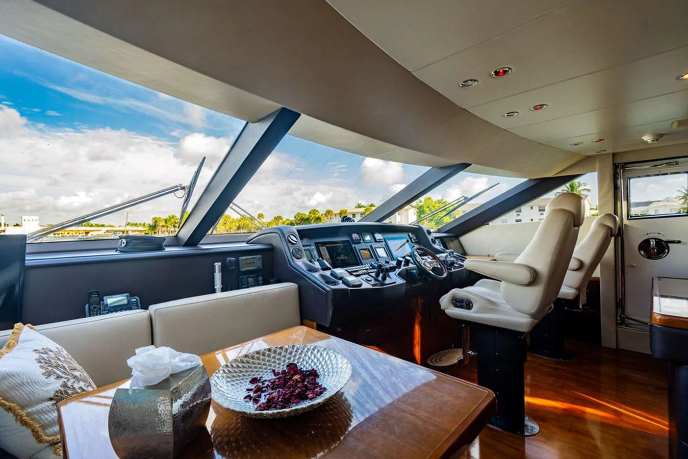 The helm station offers a commanding view with luxurious seating and advanced navigation equipment. aboard OASIS Yacht for Sale