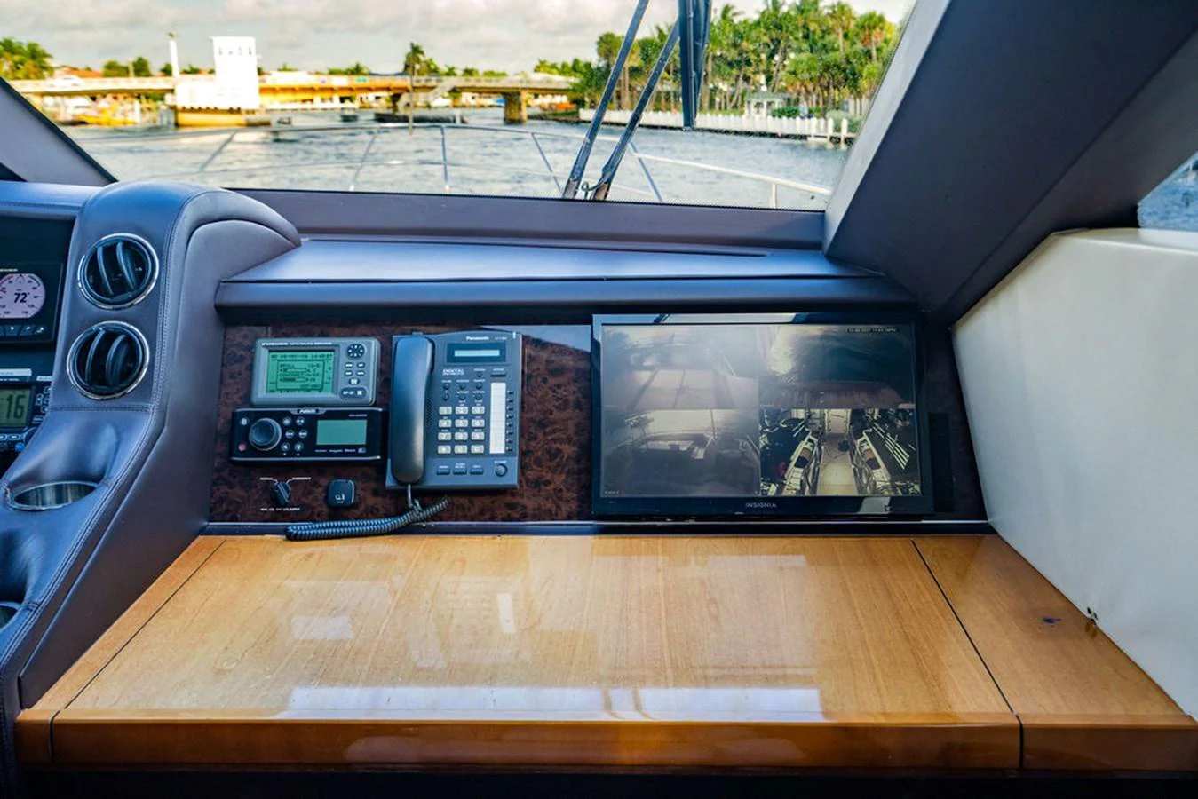 The helm station features advanced navigation equipment and a sleek wooden console. aboard OASIS Yacht for Sale