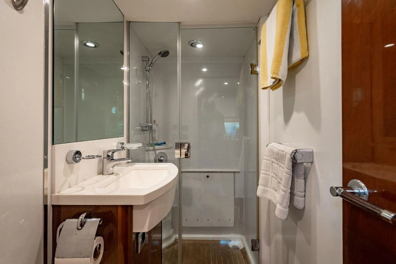 The yacht's bathroom features a modern shower, sleek sink, and elegant fixtures. aboard OASIS Yacht for Sale