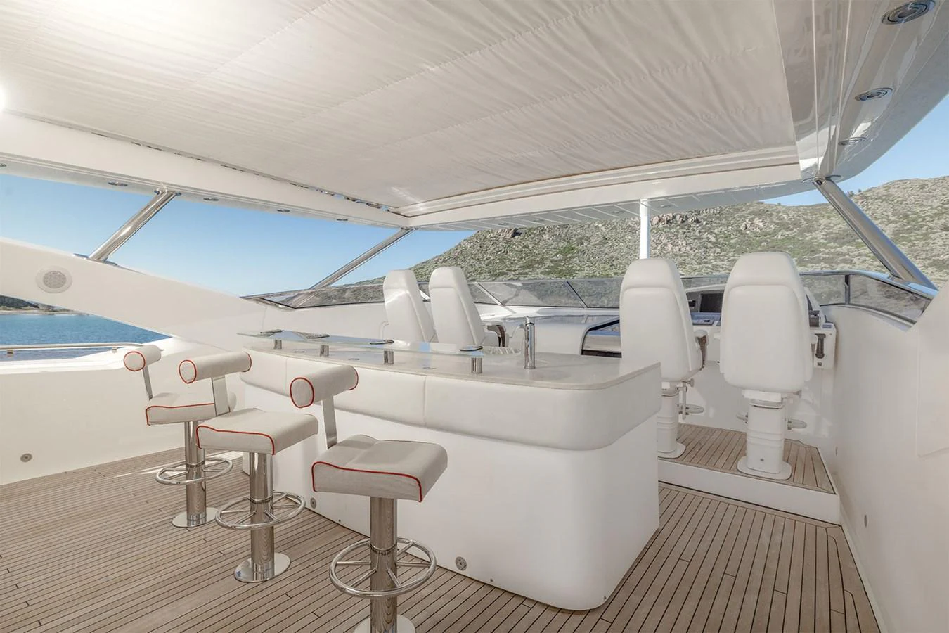 The flybridge features a sleek bar area with modern seating and panoramic views. aboard FINAL CUT Yacht for Sale