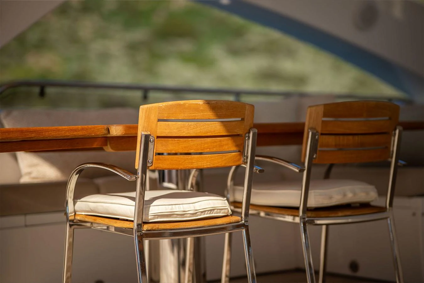 The yacht features a cozy outdoor dining area with comfortable seating and a wooden table. aboard FINAL CUT Yacht for Sale
