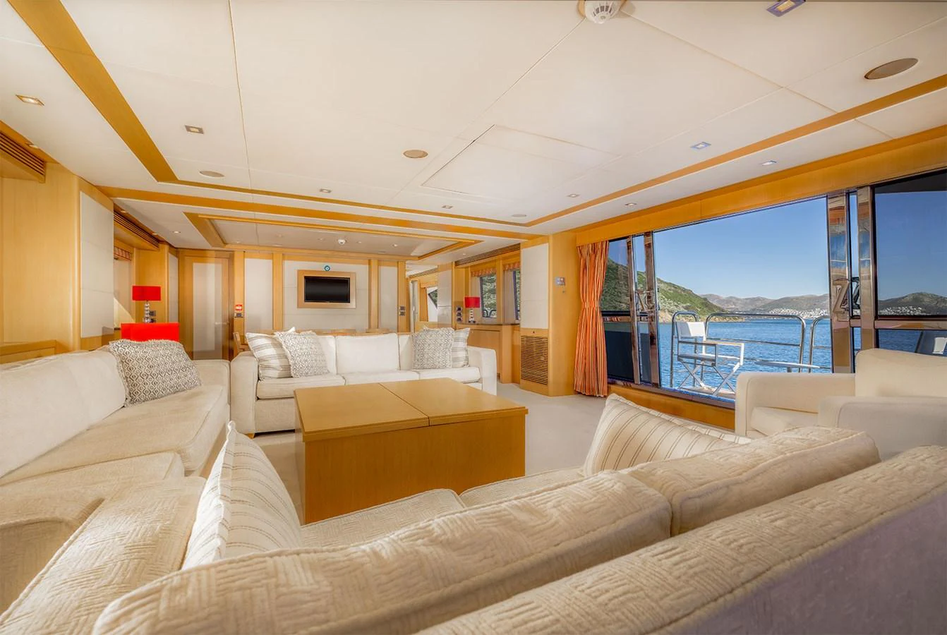 The spacious salon offers a luxurious and comfortable setting with ample seating and stunning views of the surrounding waters. aboard FINAL CUT Yacht for Sale