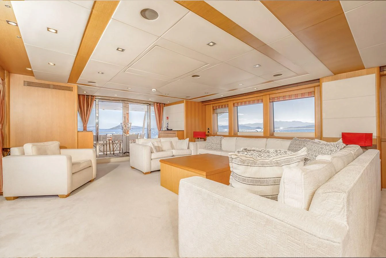 The salon offers a spacious and luxurious seating area with panoramic views through large windows. aboard FINAL CUT Yacht for Sale