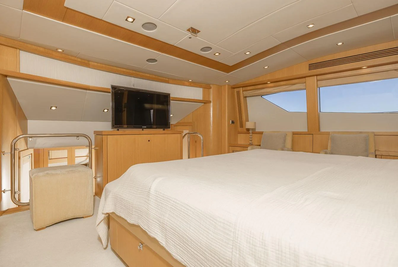 The master stateroom features a spacious bed, modern furnishings, and large windows for natural light. aboard FINAL CUT Yacht for Sale