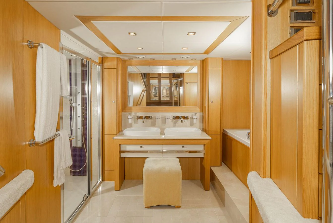 The yacht's bathroom features a luxurious double sink vanity and a spacious shower area. aboard FINAL CUT Yacht for Sale