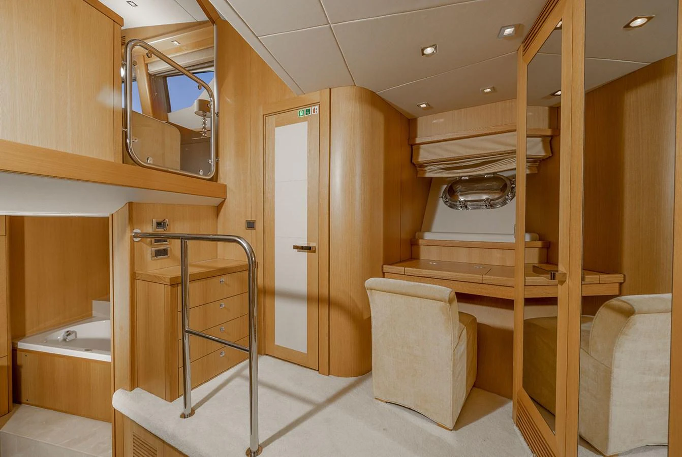 The yacht's interior features a cozy and well-lit space with light wood finishes and comfortable seating. aboard FINAL CUT Yacht for Sale