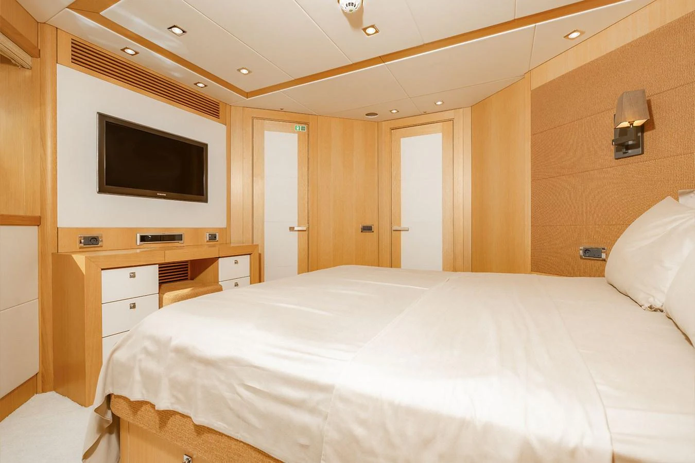 The stateroom features a cozy and elegant design with light wood finishes and modern amenities. aboard FINAL CUT Yacht for Sale