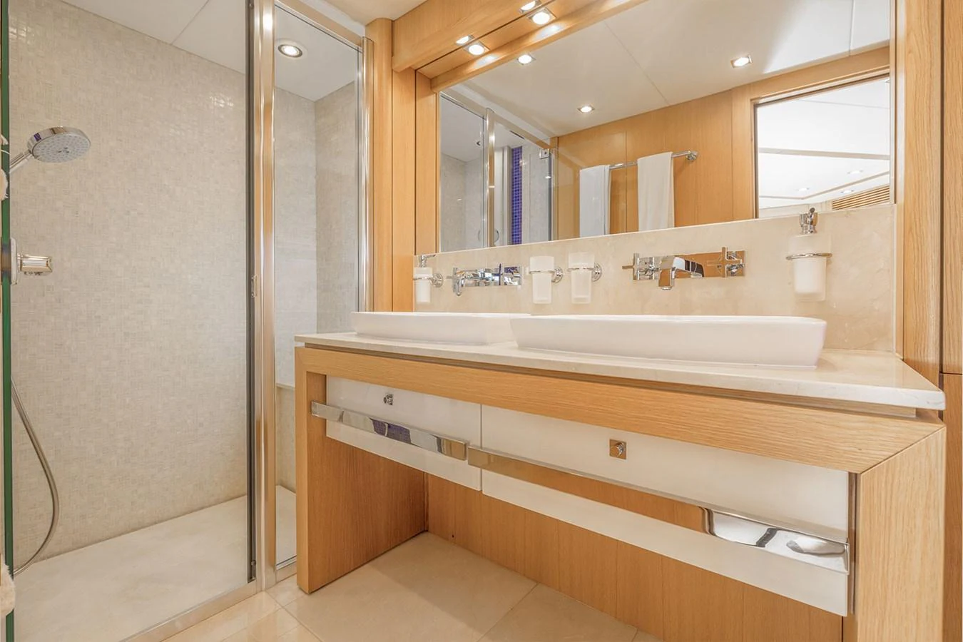The yacht's bathroom features a sleek design with modern fixtures and ample lighting. aboard FINAL CUT Yacht for Sale