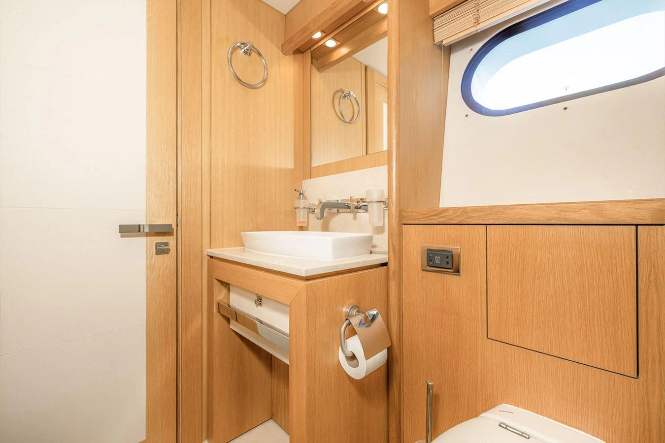 The yacht's bathroom features modern fixtures and a sleek design with light wood finishes. aboard FINAL CUT Yacht for Sale