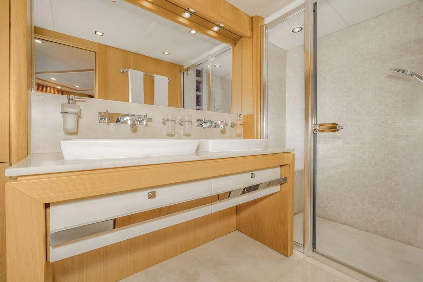 The yacht's bathroom features a modern design with a spacious shower and dual sinks. aboard FINAL CUT Yacht for Sale