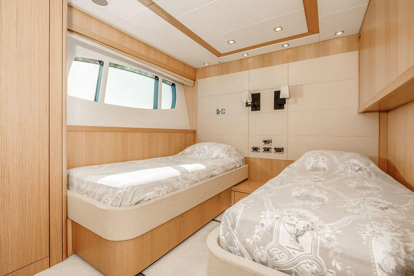 The guest stateroom features twin beds and elegant wood paneling, creating a cozy and inviting atmosphere. aboard FINAL CUT Yacht for Sale