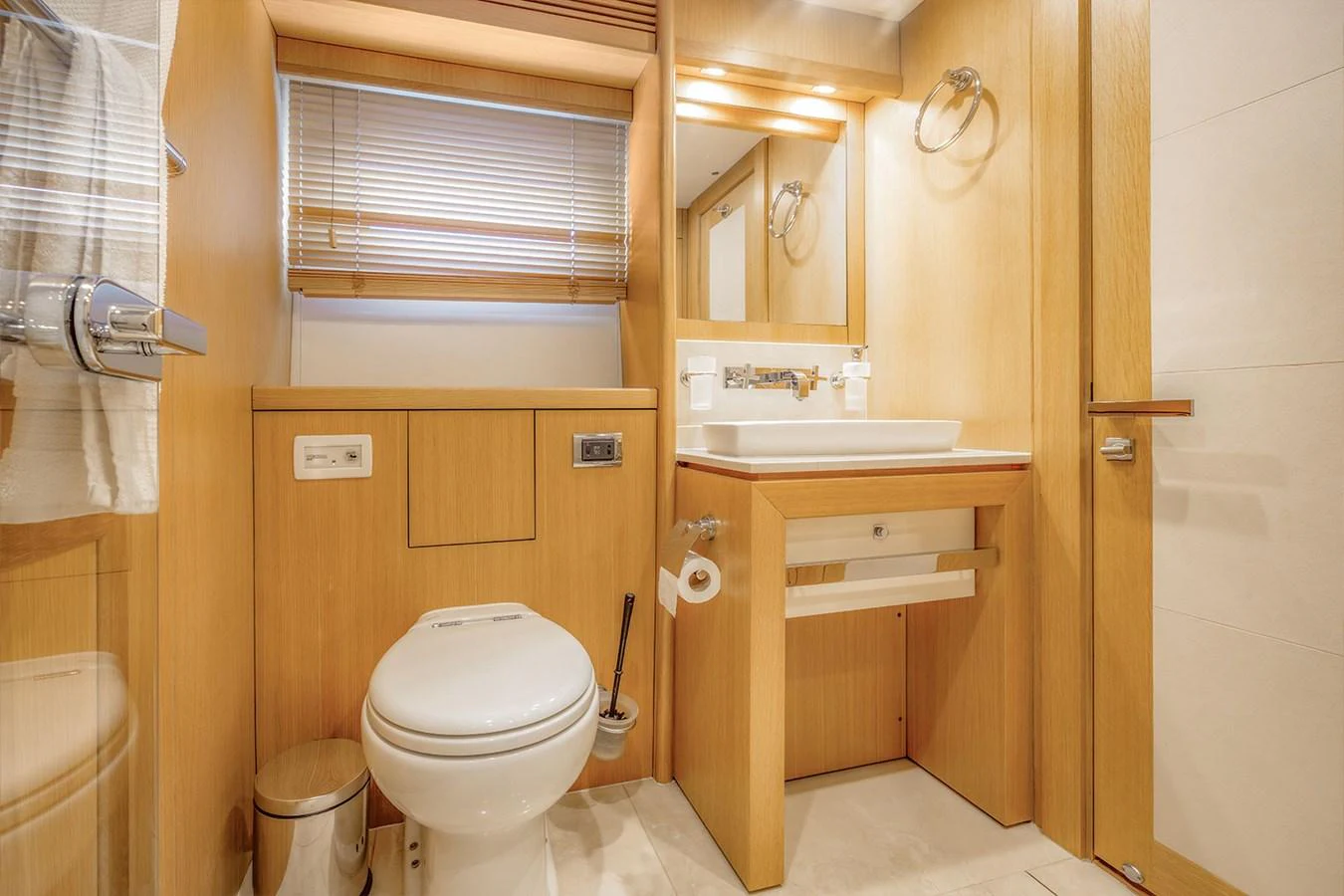 The yacht's bathroom features modern fixtures and a warm wooden finish. aboard FINAL CUT Yacht for Sale