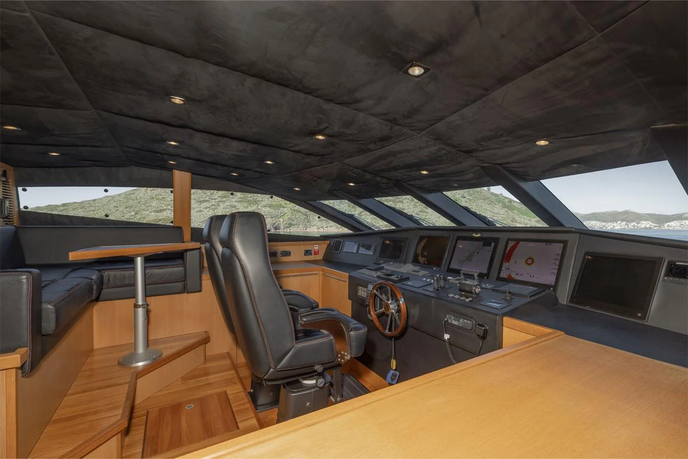 The helm of the yacht features advanced navigation equipment and a luxurious captain's chair. aboard FINAL CUT Yacht for Sale