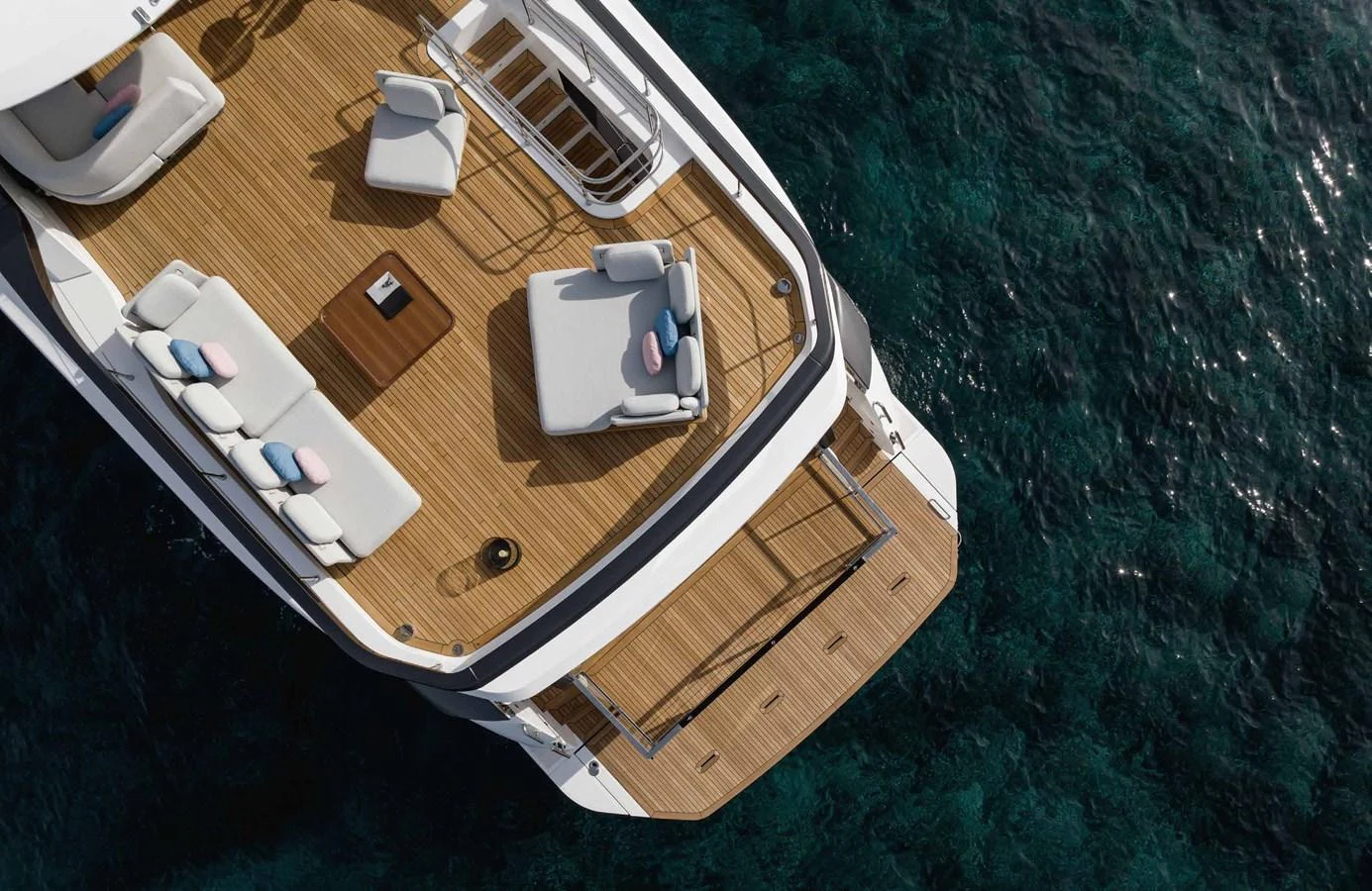 The yacht's aft deck features a spacious seating area with elegant furnishings overlooking the water. aboard MARYBELLE Yacht for Sale