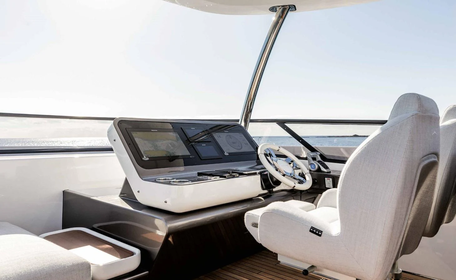 The helm station features modern navigation equipment and comfortable seating with a view of the sea. aboard MARYBELLE Yacht for Sale