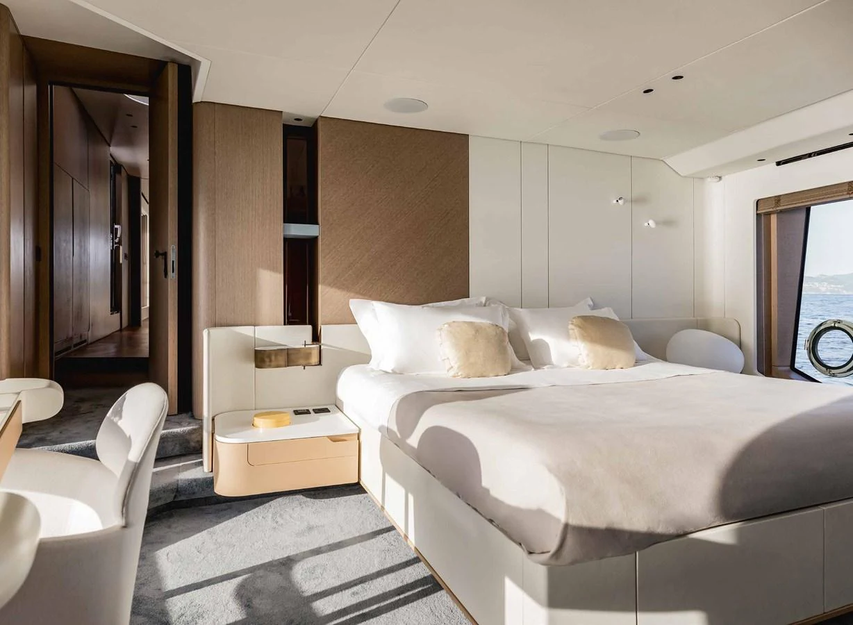 The stateroom features a luxurious bed with elegant decor and ample natural light. aboard MARYBELLE Yacht for Sale