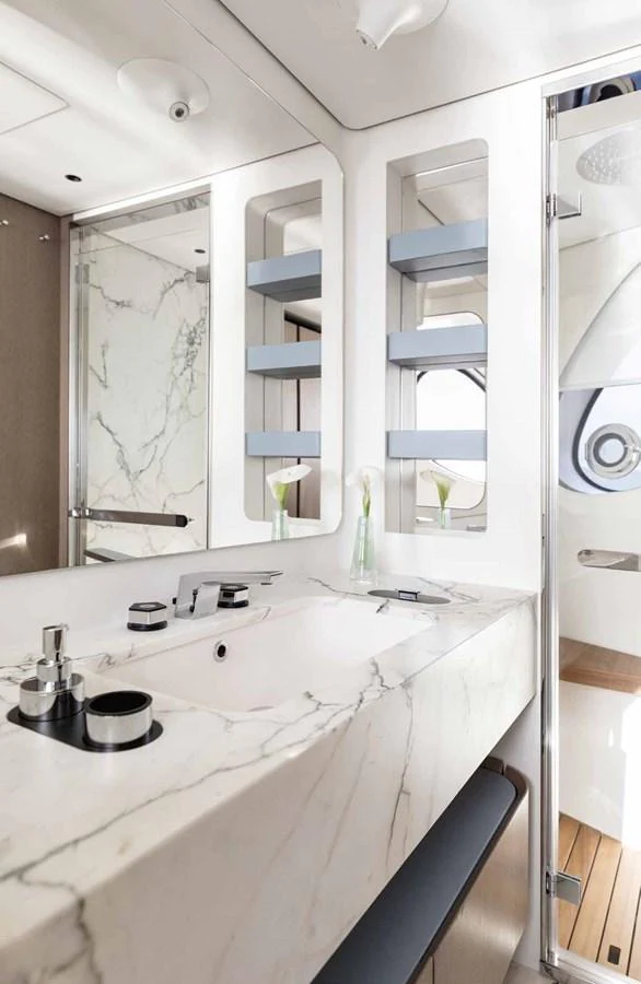 A luxurious yacht bathroom featuring a marble countertop and modern fixtures. aboard MARYBELLE Yacht for Sale