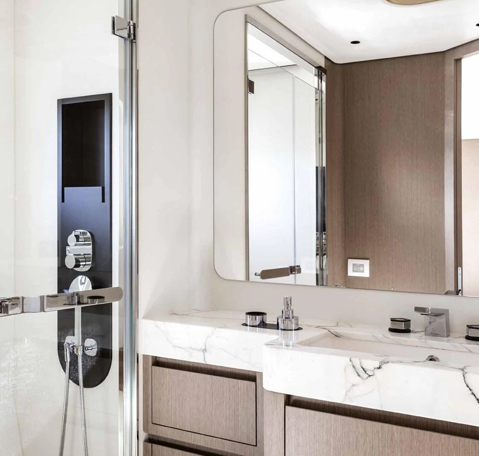 The yacht's bathroom features modern fixtures and elegant marble countertops. aboard MARYBELLE Yacht for Sale