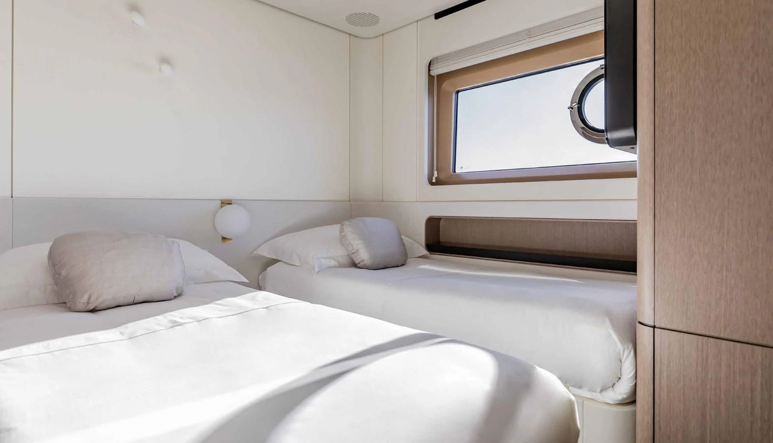A cozy guest cabin with two single beds and a window providing natural light. aboard MARYBELLE Yacht for Sale