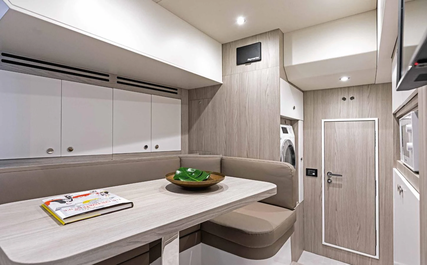 The yacht's dining area features a cozy seating arrangement with a table and modern decor. aboard MARYBELLE Yacht for Sale