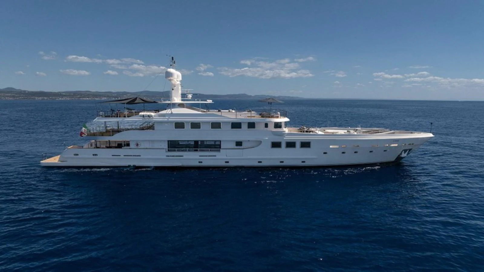 A sleek and elegant yacht cruising on calm blue waters under a clear sky. aboard R23 Yacht for Sale