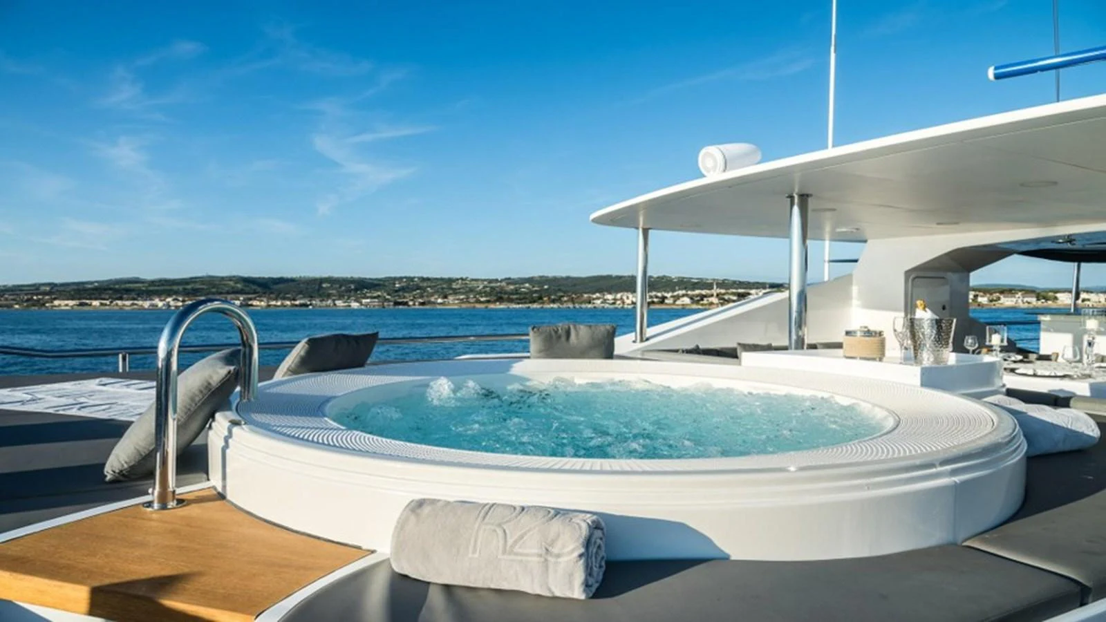 The sundeck features a luxurious jacuzzi with stunning views of the surrounding waters. aboard R23 Yacht for Sale