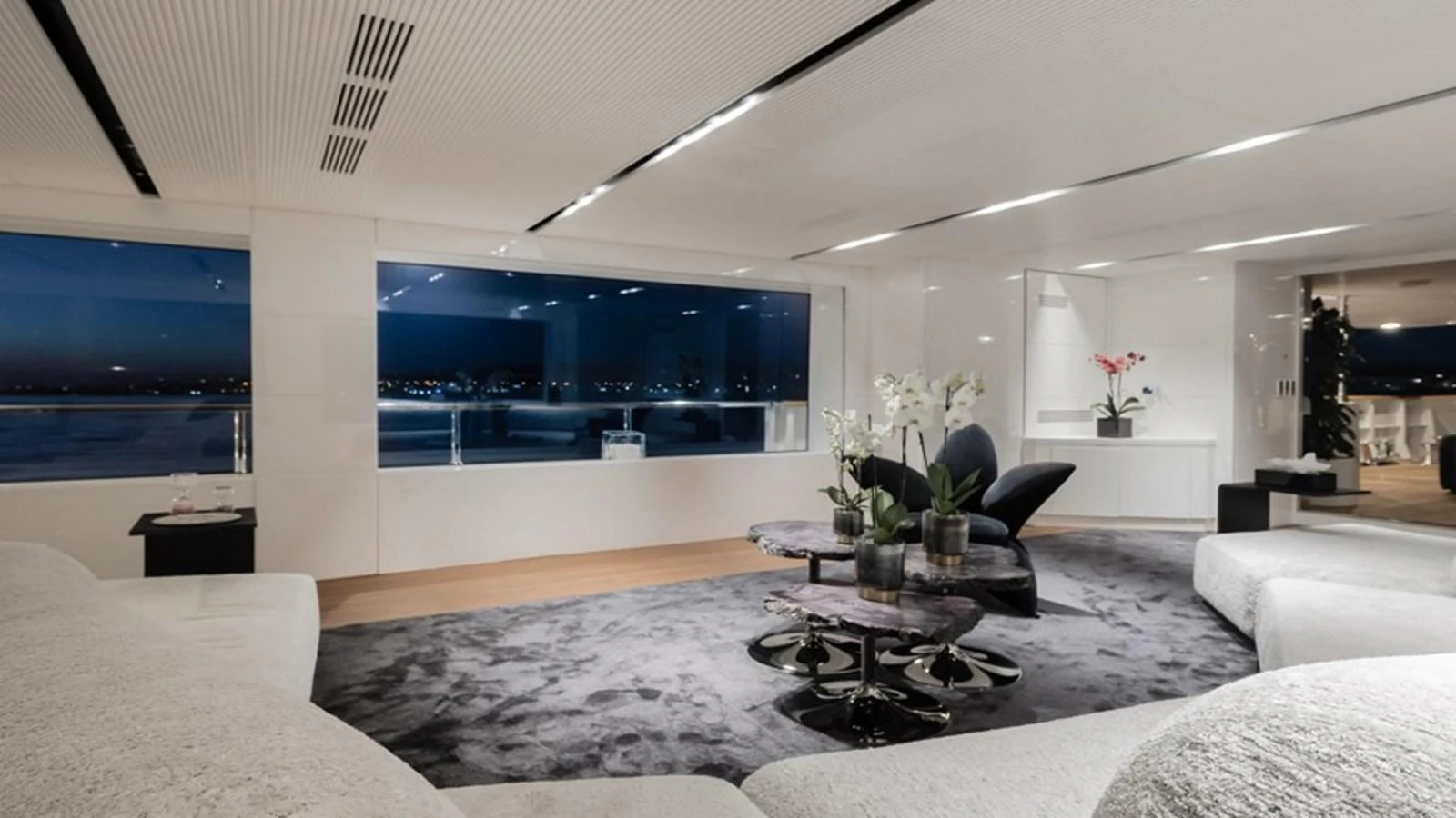 The salon features a spacious and modern design with large windows offering stunning views. aboard R23 Yacht for Sale
